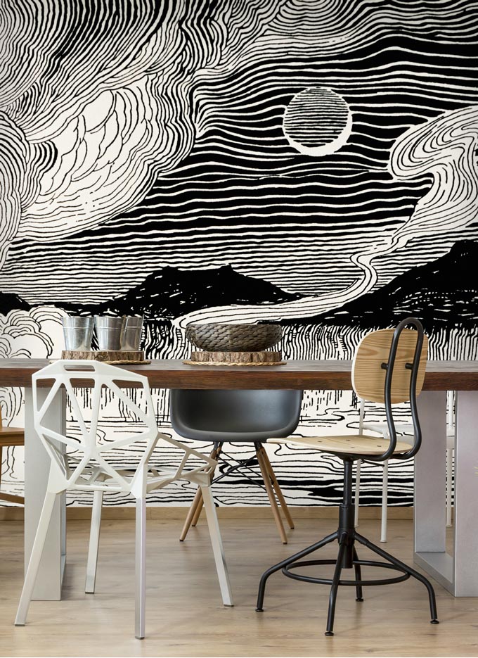 A black and white mural of a moon over a volcano. Image via Wallsauce.