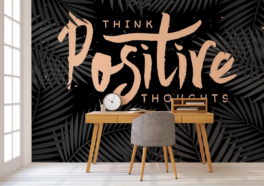 Think positive thoughts wall mural in the background and a study desk in the foreground. Image by Wallsauce.