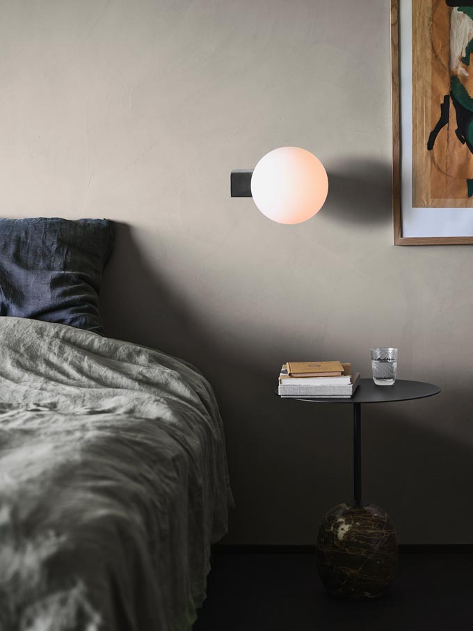 I love this wall light over that side table by the bed in this light olive green bedroom. Image via Nest.co.uk.