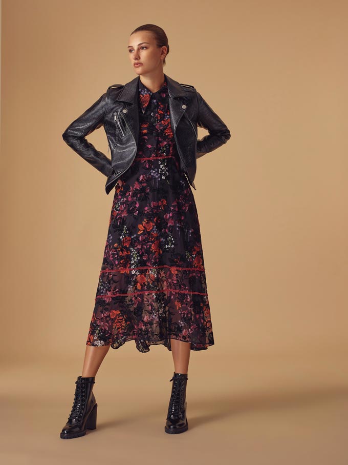 Winter outfits lookbook: A print winter dress paired with a black biker's jacket and ankle boots. Image via Very.co.uk.