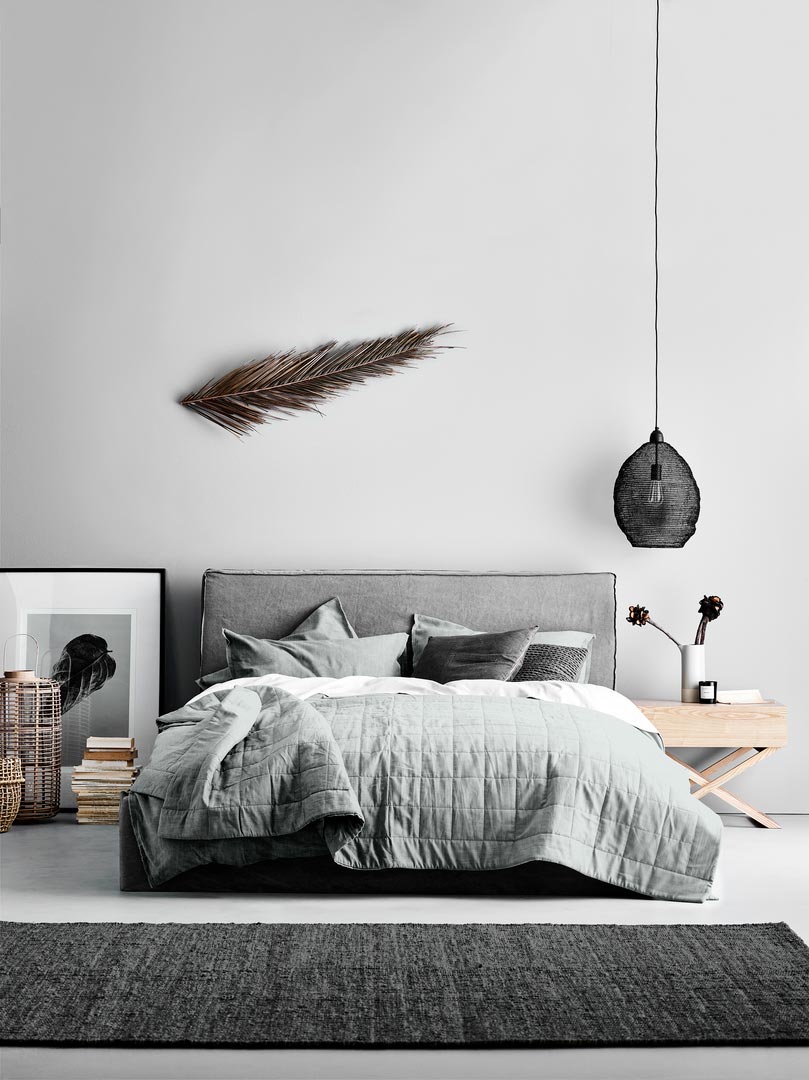 A grey Scandi-boho chic bedroom with a relaxed vibe. Notice how the bedding helps create that look Image by Aura Home.