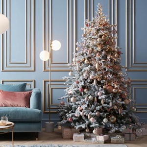 A beautifully styled Christmas tree with blush pink baubles. Image via John Lewis.