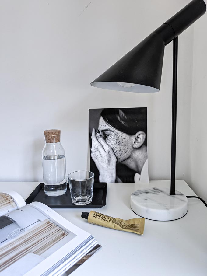 A small table lamp with a white marble base on a white desk. Image via Cult Furniture. Marble decor ideas.