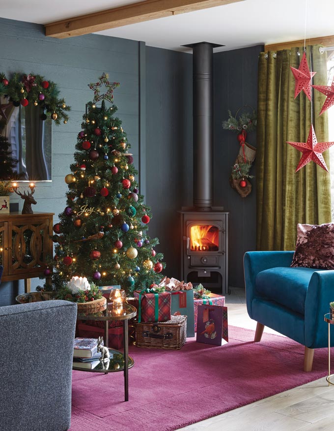Gold and red decorations for a green Christmas tree. Traditional yet timeless. Image via Dunelm.