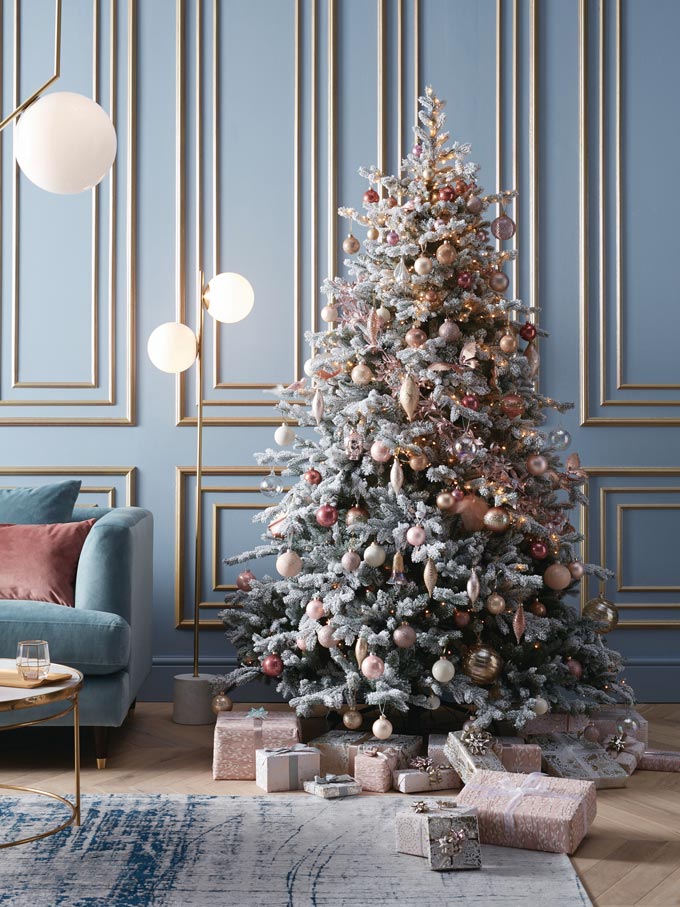 A beautifully styled Christmas tree with blush pink baubles. Image via John Lewis.