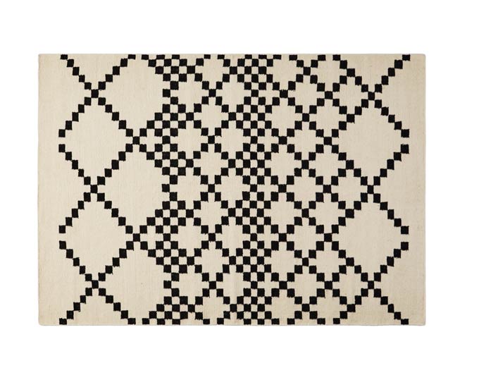 A cut out image of cream and navy pattern wool rug with a Bieber style. Image via Swoon.