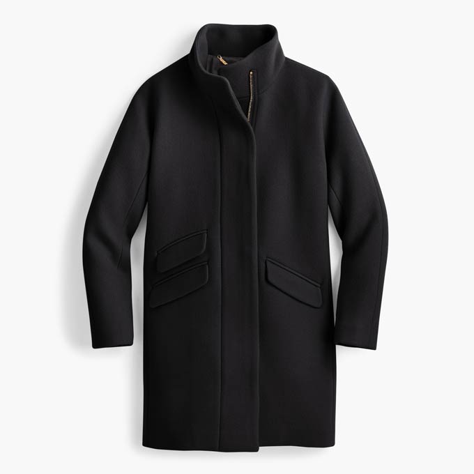 A flat lay of a black wool coat. Image via J.Crew.