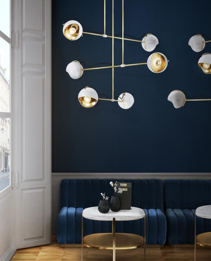 A naval blue inspired room with white accents and brass details. Image by Essential Home.