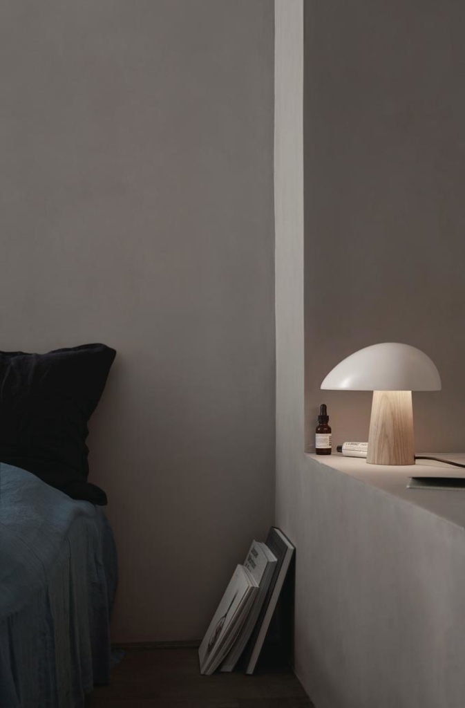 The Fritz Hansen night owl table lamp resting on a nearby shelf in a bedroom. Image via Nest.co.uk.