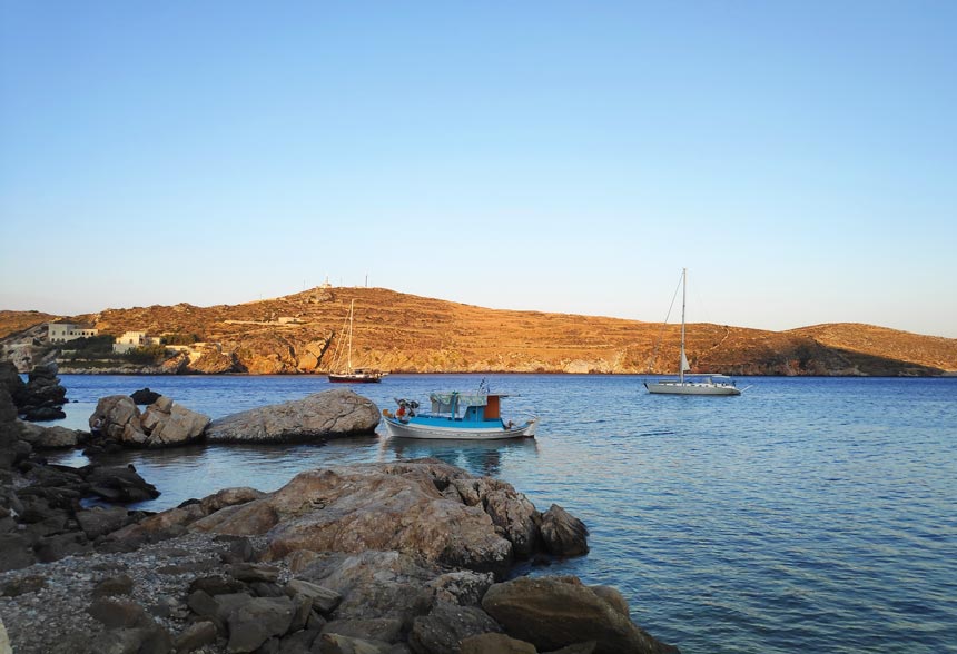 A seascape with two sailing boats and a fishing boat in Syros in landscape format.