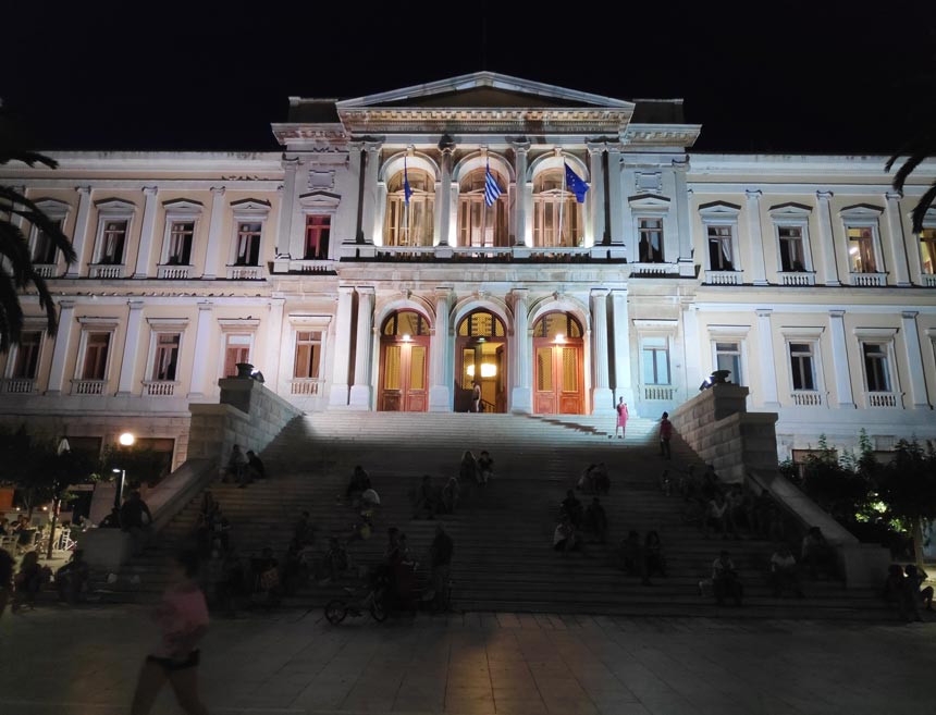 The Town Hall of Hermoupolis in Syros at night, pictured with a smartphone.