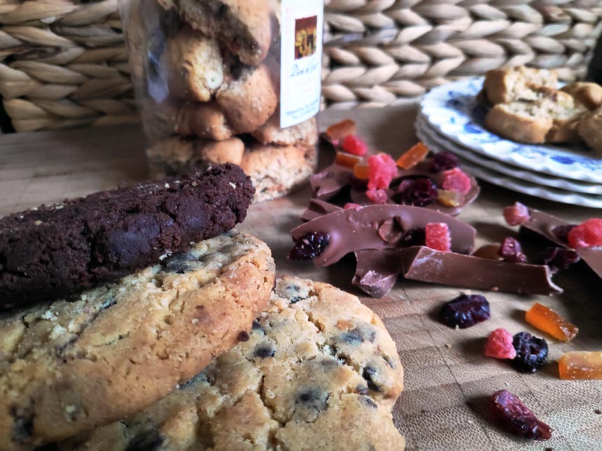 Cookies and chocolate bits on a cutting board.