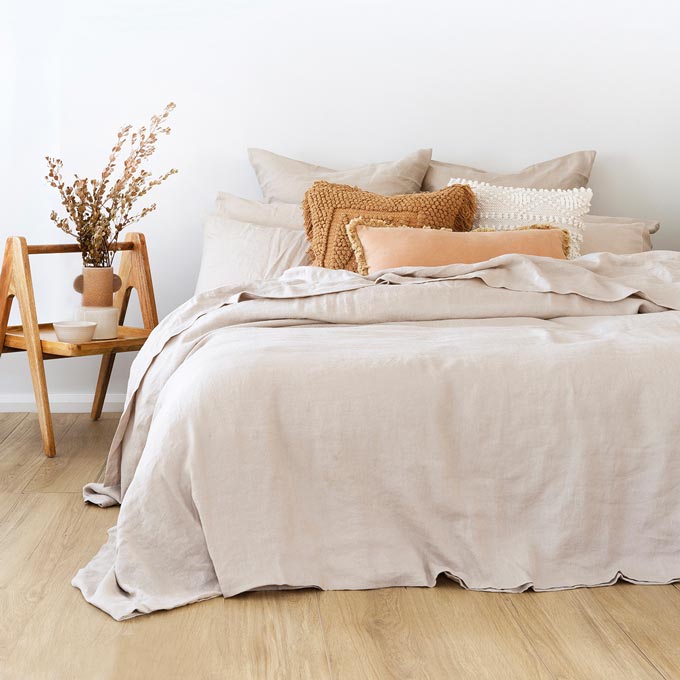 A stylish Scandinavian chic bright bedroom with an eye-catching nightstand and beautiful linen bedding. Photo: Bambury..