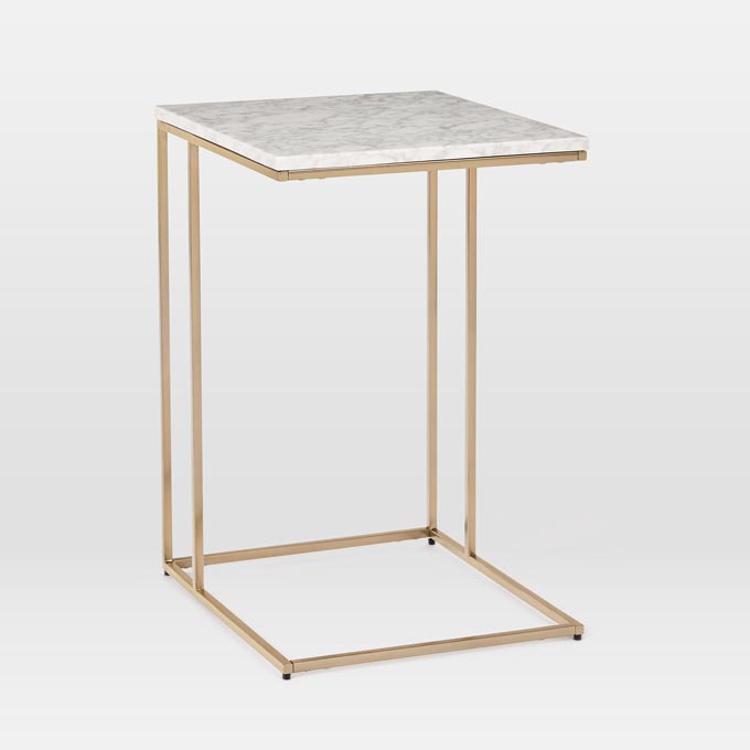 A side table with a white marble top and brassy frame like this can make a great looking bedside table. Photo: West Elm.