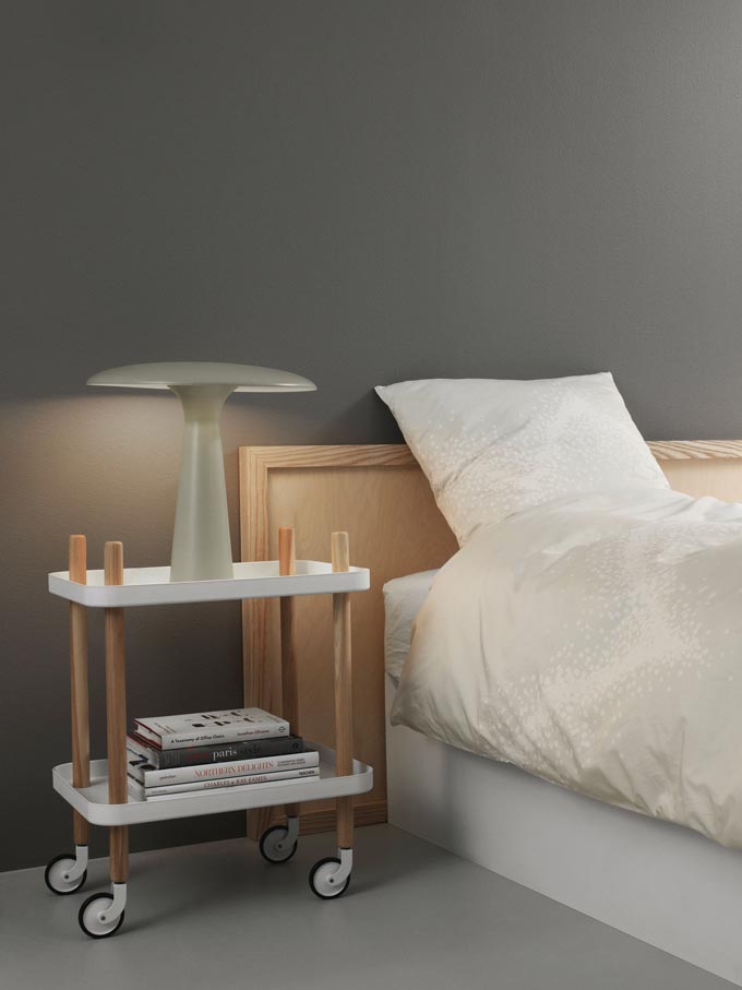 Normann Copenhagen Block Side Table serving as a nightstand in a muted green bedroom. Gorgeous. Image: Nest.co.uk.