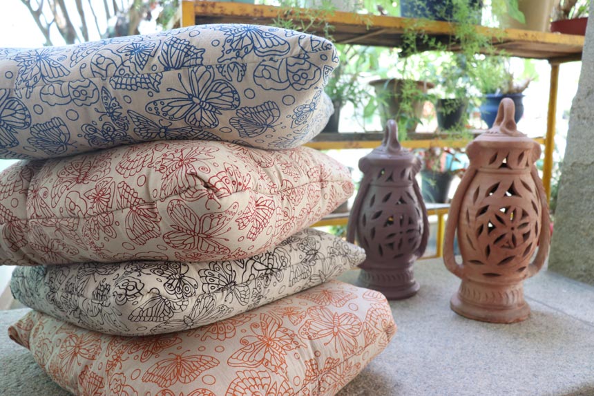 A stack of four pillows with a butterfly print on them. Image: Secret Projects.