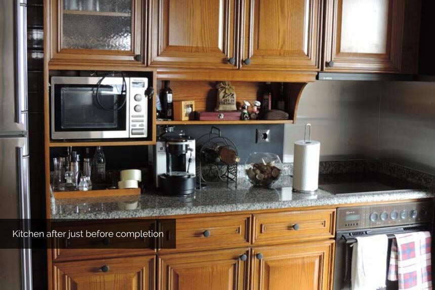 A galley kitchen just before its makeover was completed (landscape format).