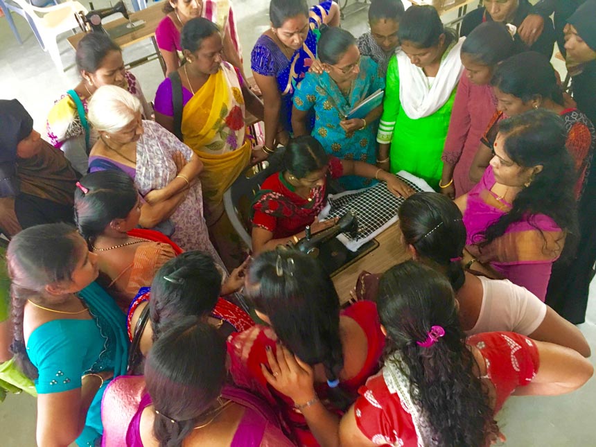 A woman sewing away surrounded with other women during the Secret Pillow project training in India. Image: Secret Projects.