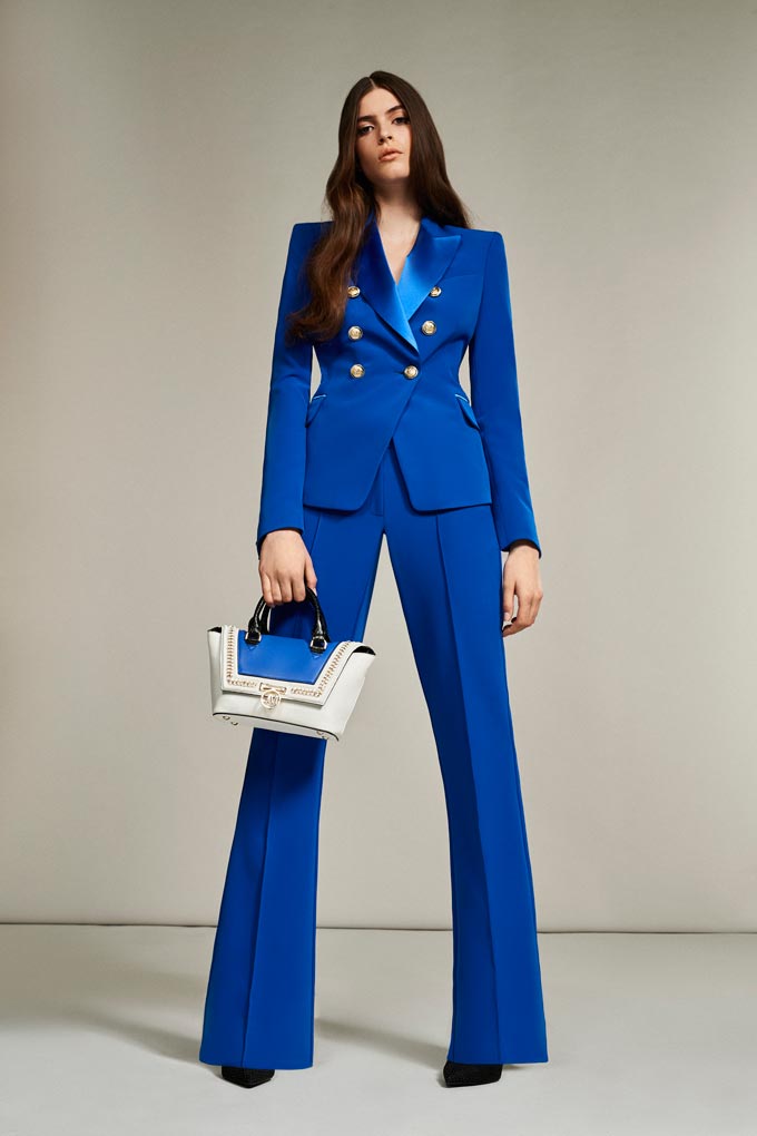 A Pantone's Classic Blue power suit styled with a white and blue handbag. Trendy and eye catching. Image: Debenhams.