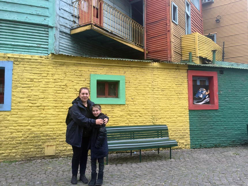 Eva and Michael posing in front of colorful facades at the notorious El Caminito during the trip in Argentina.