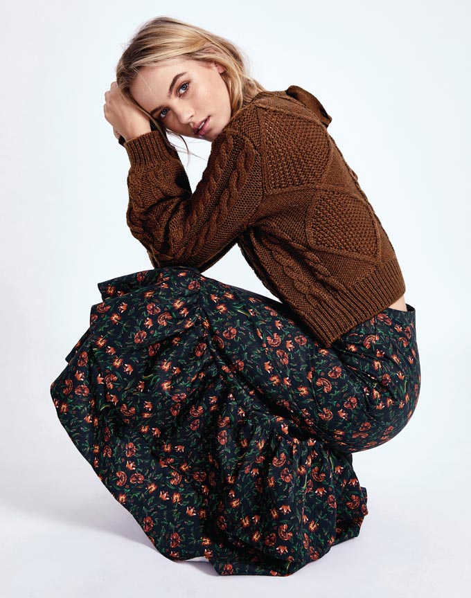 A brown pullover paired with a dark green midi skirt with a small flower print. Image: Morrison.