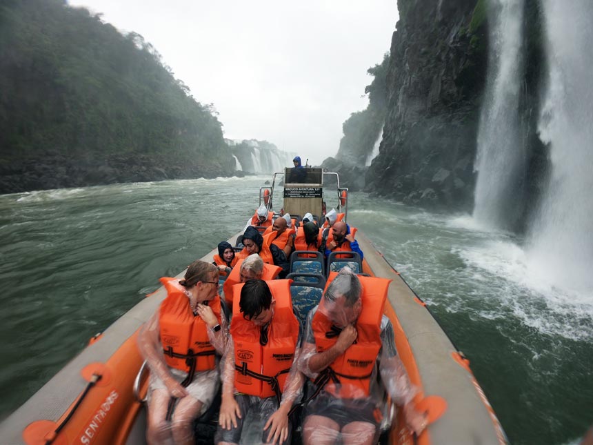 Tourists including Eva and Michael soaking wet in a boat ride by the Iguazu Falls.