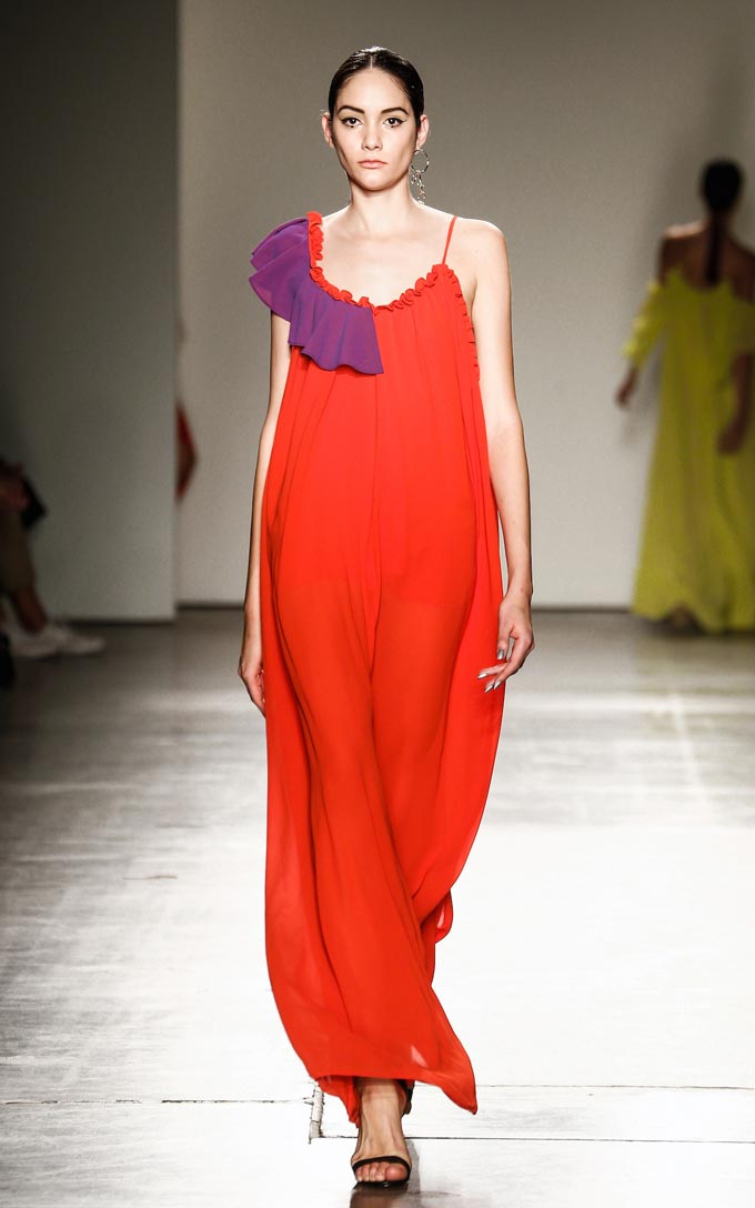 Asymmetrical pull over sheer maxi dress with left side seam slit. Contrasting frill and gathered detail on front and back. Image: Haus of Song.