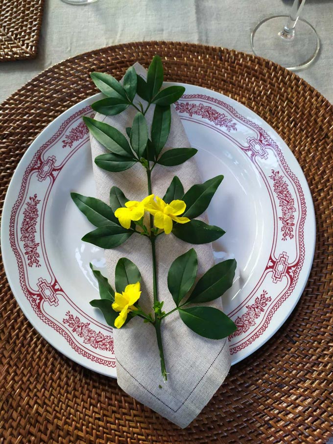 A place setting for Easter dining, set up by Elisabeth with a yellow wildflower as decor.