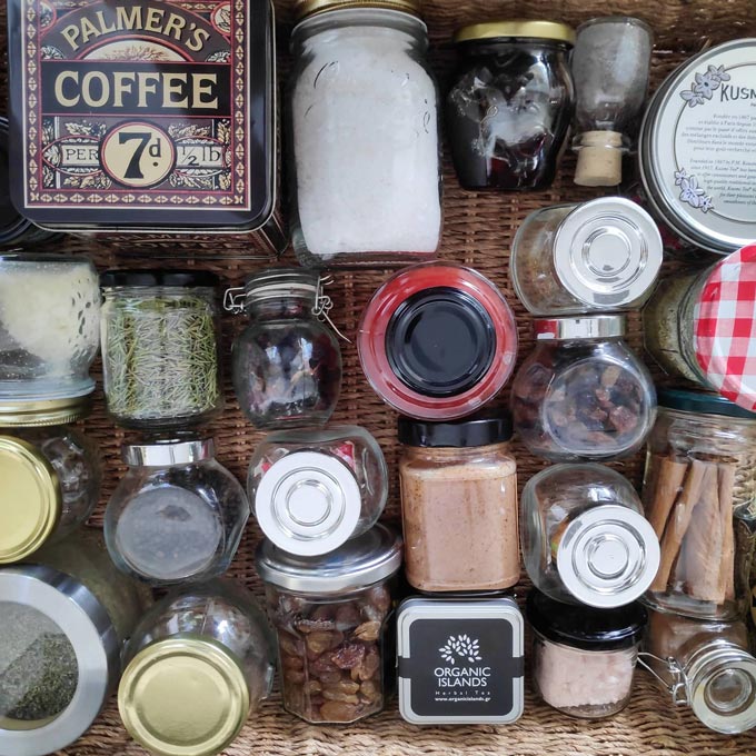 A flatlay image of bottled spices, herbs and coffee beans.