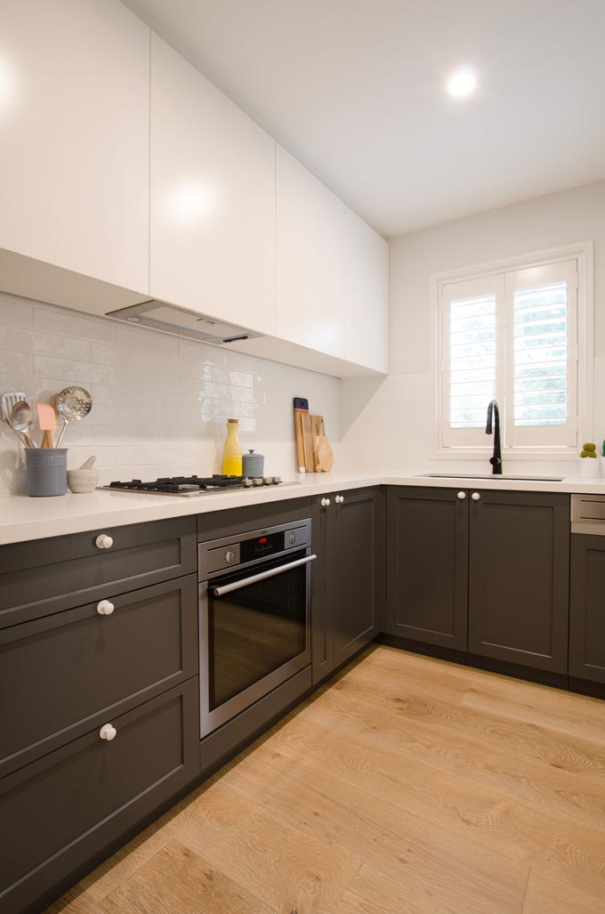 Side view of a contemporary kitchen with hardwood flooring and white upper cabinetry. Image: Meir Australia Pty Ltd.