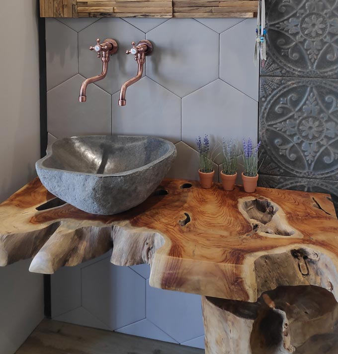 On top design crimes: A grey stone vessel sink resting on a rustic counter - an interior design crime unless you are prepared for its high maintenance. Image by Velvet Karatzas.