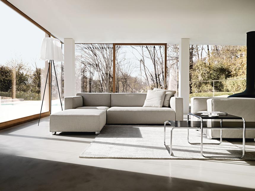 A contemporary living room filled with natural light, a sectional off white sofa and a nest of Low Tables designed by Marcel Breuer. They're now a perfect example of Bauhaus design.