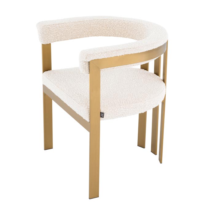 A stylish Mid-Century inspired dining chair in a white boucle fabric upholstery. Via Sweetpea and Willow.