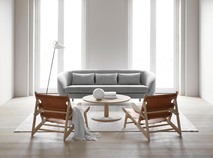A minimal living room featuring a grey sofa and the Fredericia Hunting Chairs. Via Nest.co.uk.