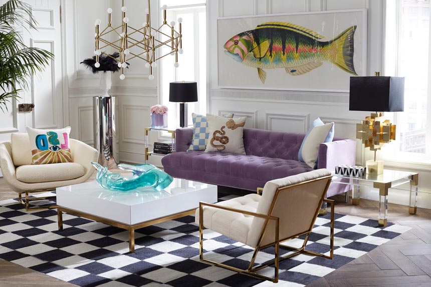 An eclectic living room featuring a purple velvet sofa and two Mid-Century inspired chairs. Via Sweetpea and Willow.