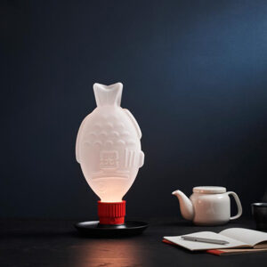 The Light Soy lamp styled on a desk next to a white tea pot. Via Heliograf.