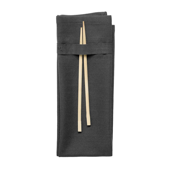 Cut out image of a grey napkin with a strap that holds the cutlery. Via Coffee & Cloth ltd.
