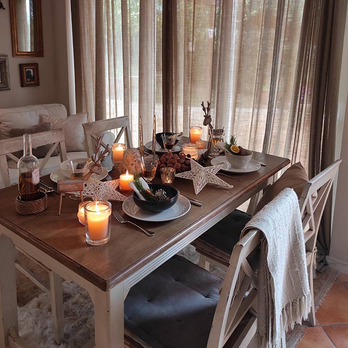 A sideways view of a simple Christmas table setting in neutral tones.