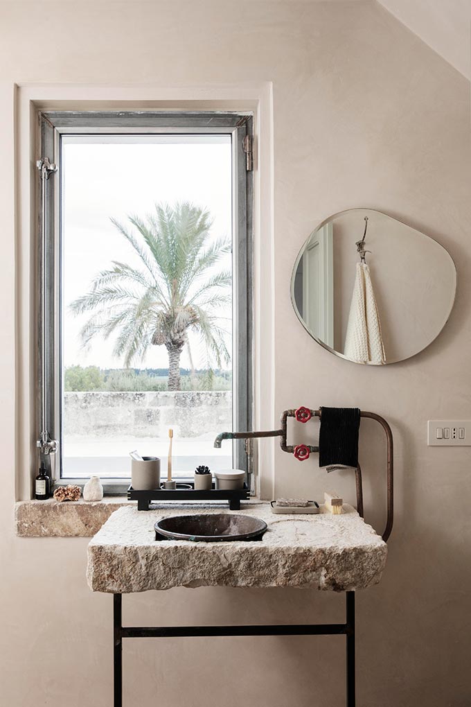 An organic but very stylish bathroom featuring the Ferm Living Pond Mirror with its organic shape. Image via Nest.co.uk.