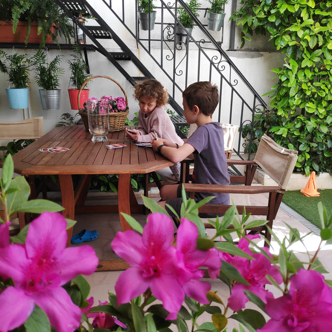 Playing a card game in a backyard with a small vertical city garden.