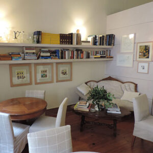 The reading nook found in the breakfast room with its open shelving and small art gallery wall.