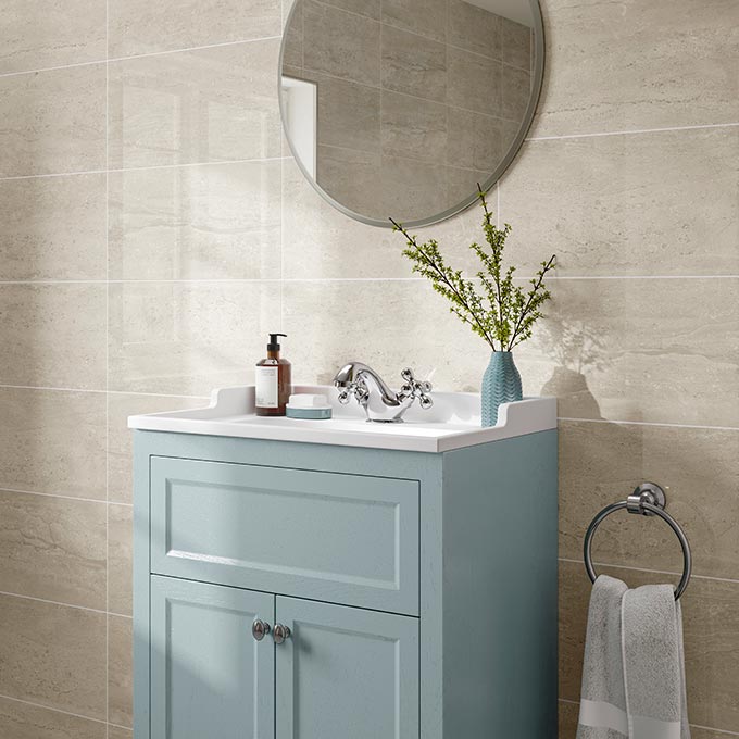 New home soothing recipe: Beige. A stylish bathroom vanity with a round mirror against a beige marble like tile wall. Via Porcelain Superstore.