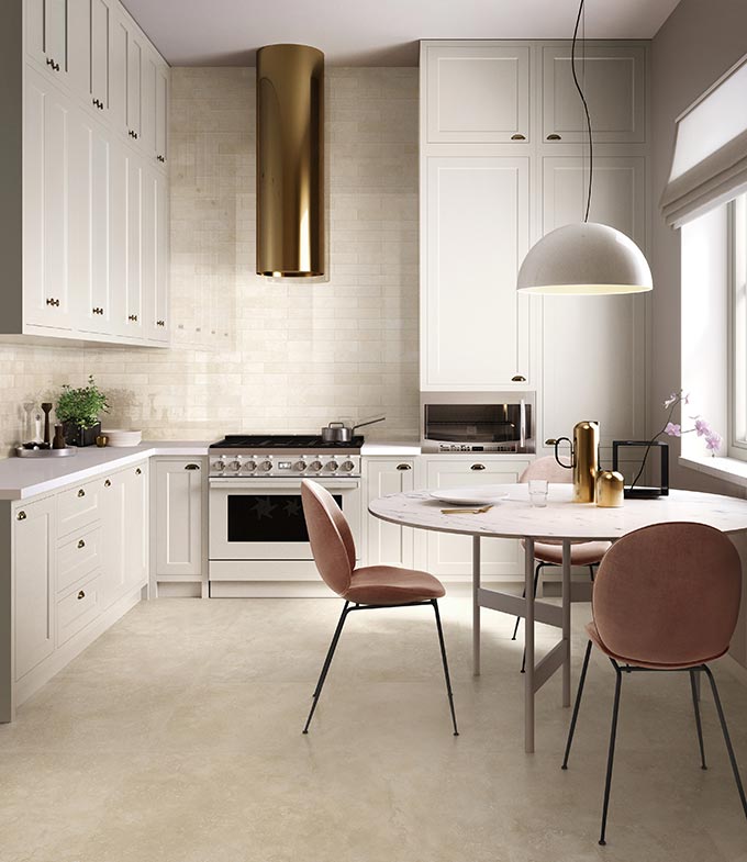 A stylish kitchen with a beige Italian travertine inspired tile and off white cabinetry. Via Porcelain Superstore.