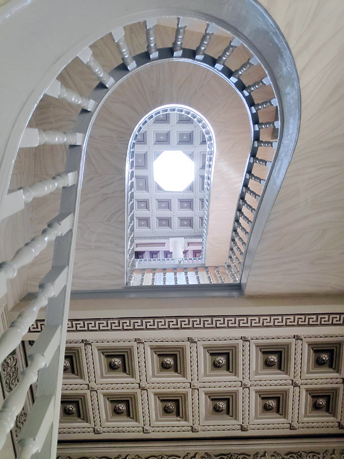 Looking up the the spiraling stairwell of the Chamber of Commerce in Hermoupolis. Image: Velvet Karatzas.