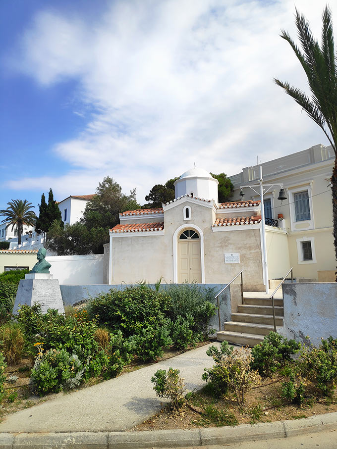 A pretty little chapel with a head bust at its front yard in Spetses.