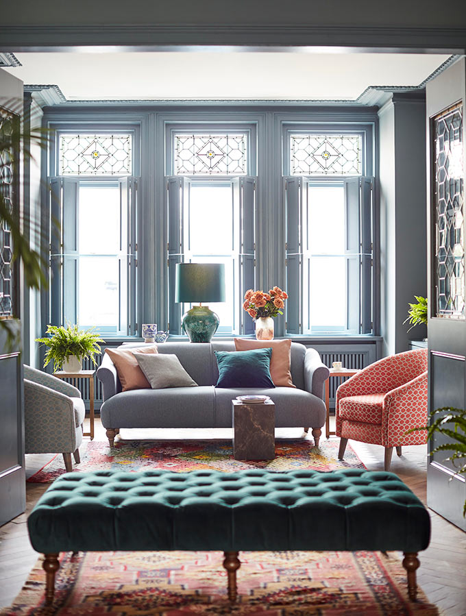 A stylish living room with a beautiful sofa, two armchairs and an ottoman. Image: DFS CO. PLC