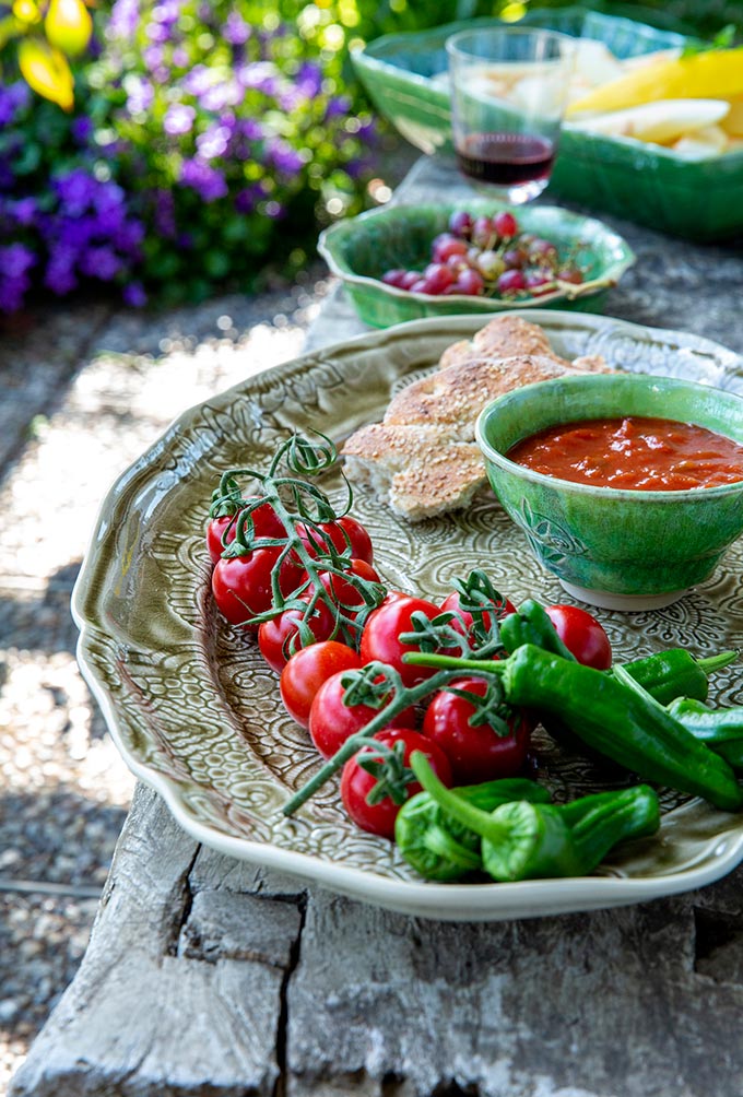 A stylish embellished platter with cherry tomatoes, peppers and a dip bowl. Via STHAL.