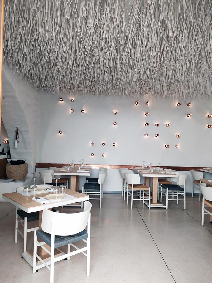 Inside a restaurant in Hermoupolis, Syros with a jaw-dropping accent white straw like ceiling. Image: Velvet Karatzas.