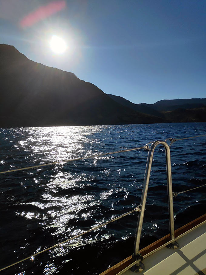 Sailing near a coastline at evening time. Image: Velvet Karatzas.