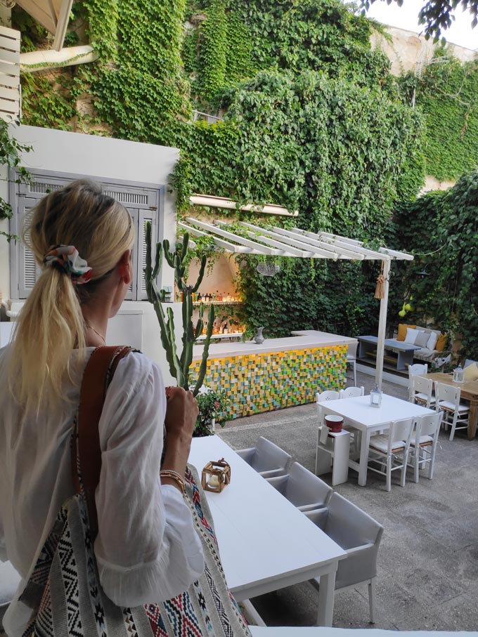 Elisabeth inside a garden restaurant in Hermoupolis - Avant Garden.